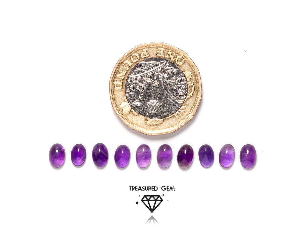 loose amethyst cabochons in oval shapes close up