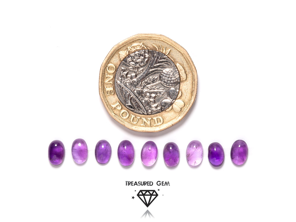 loose amethyst cabochons in oval shapes close up