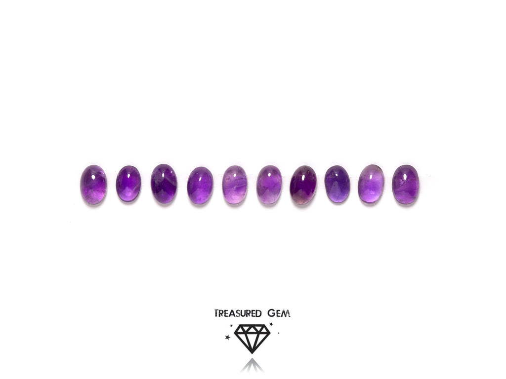 loose amethyst cabochons in oval shapes close up