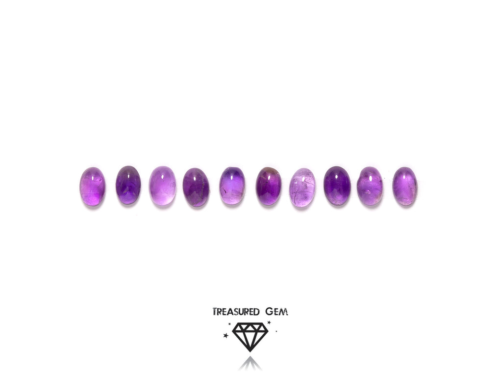 loose amethyst cabochons in oval shapes close up