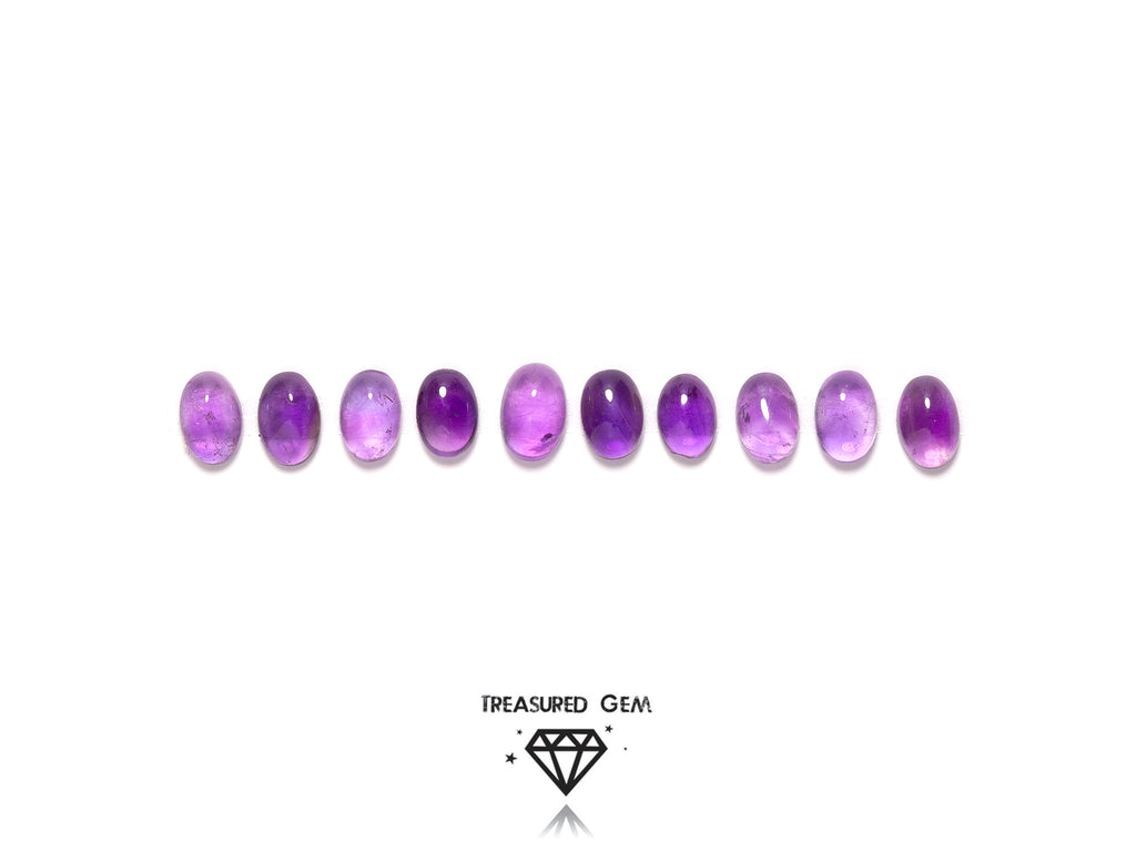 loose amethyst cabochons in oval shapes close up