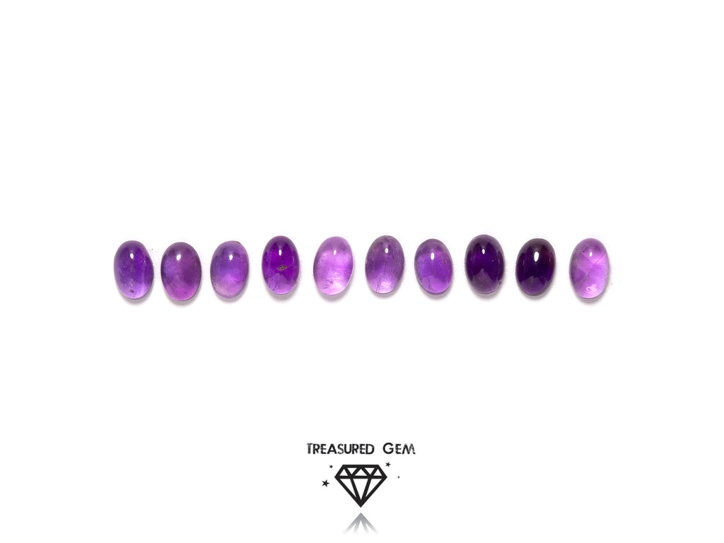 loose amethyst cabochons in oval shapes close up