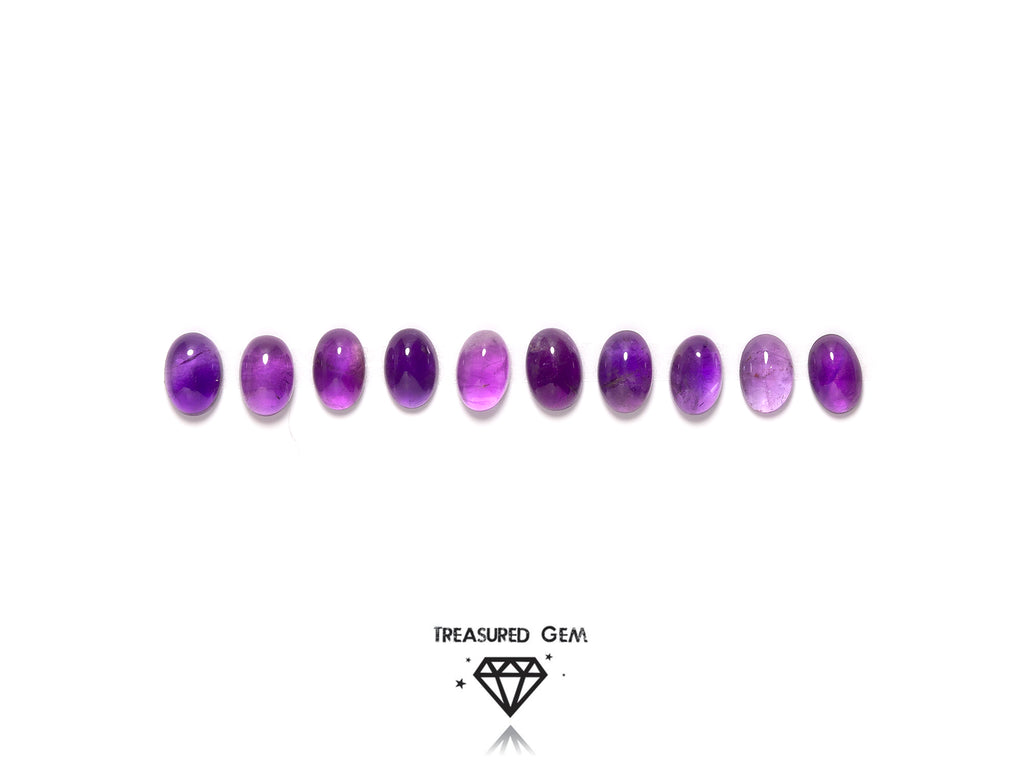 loose amethyst cabochons in oval shapes close up