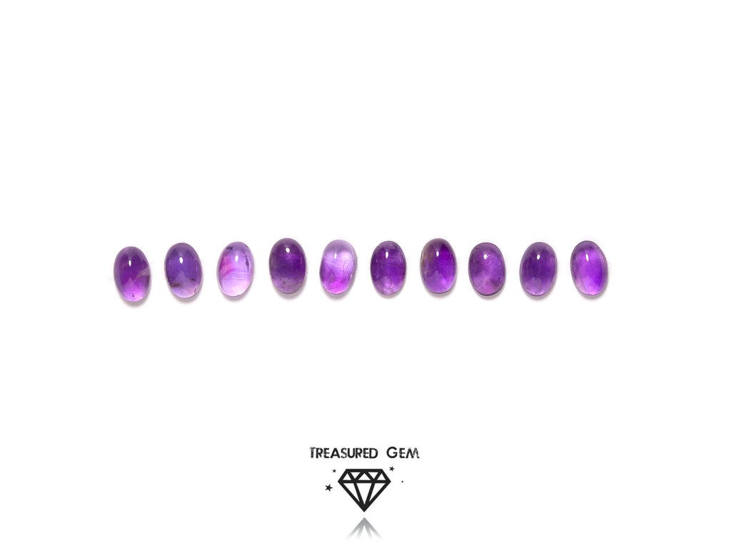 loose amethyst cabochons in oval shapes close up