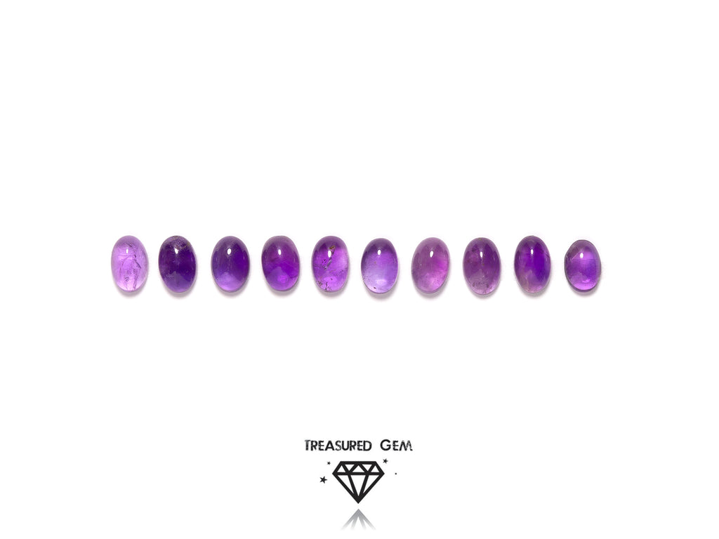 loose amethyst cabochons in oval shapes close up