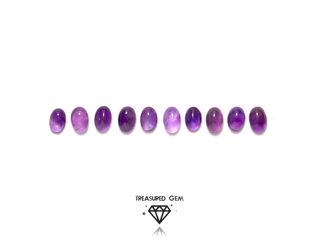 loose amethyst cabochons in oval shapes close up