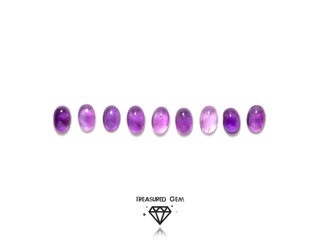 loose amethyst cabochons in oval shapes close up