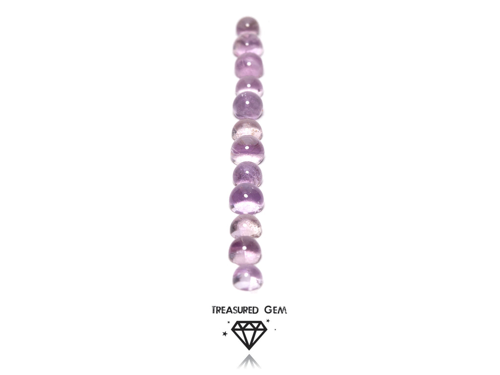 loose pink amethyst cabochons in round shapes close up