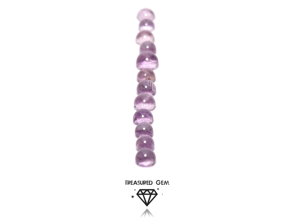 loose pink amethyst cabochons in round shapes close up