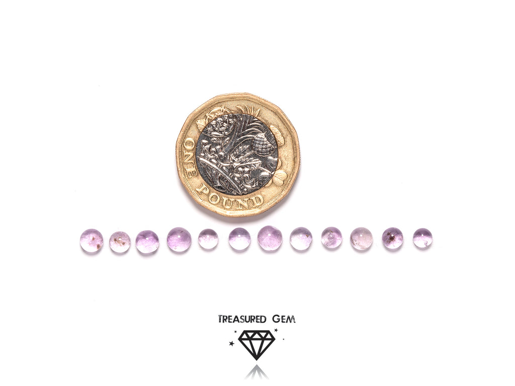 loose pink amethyst cabochons in round shapes close up