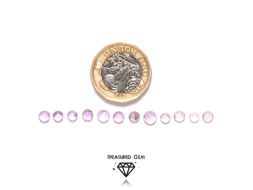 loose pink amethyst cabochons in round shapes close up