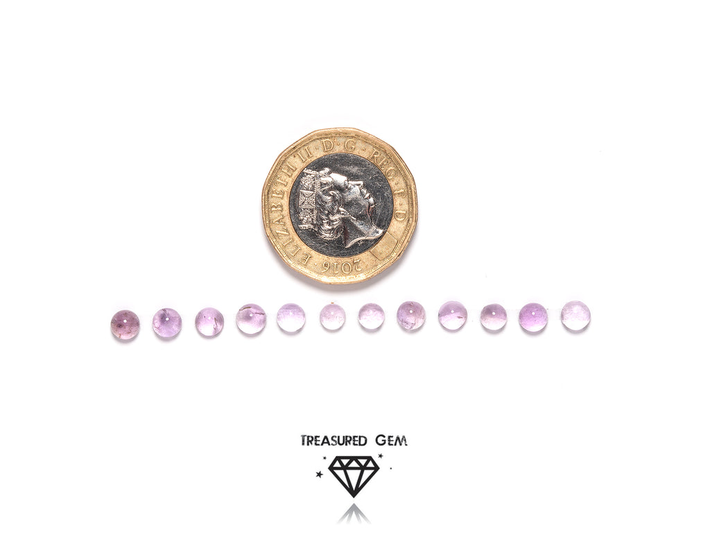 loose pink amethyst cabochons in round shapes close up