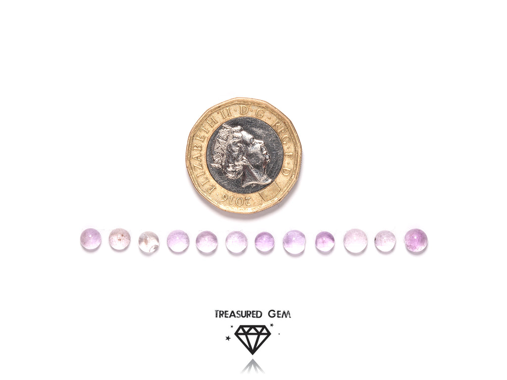 loose pink amethyst cabochons in round shapes close up